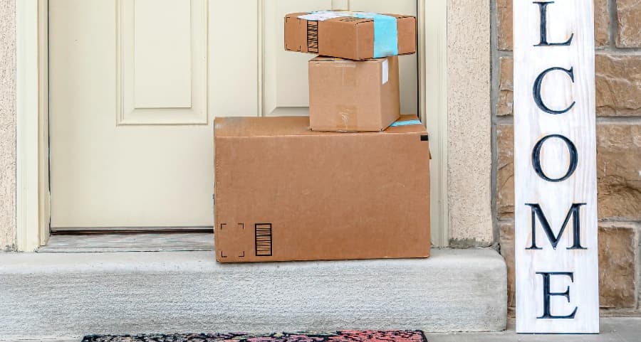 Packages on the doorstep of a home with a welcome sign in Joliet